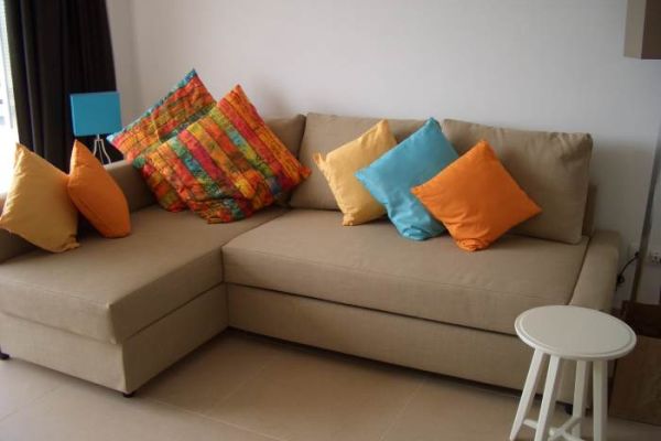 l shaped sofa with coulored cushions